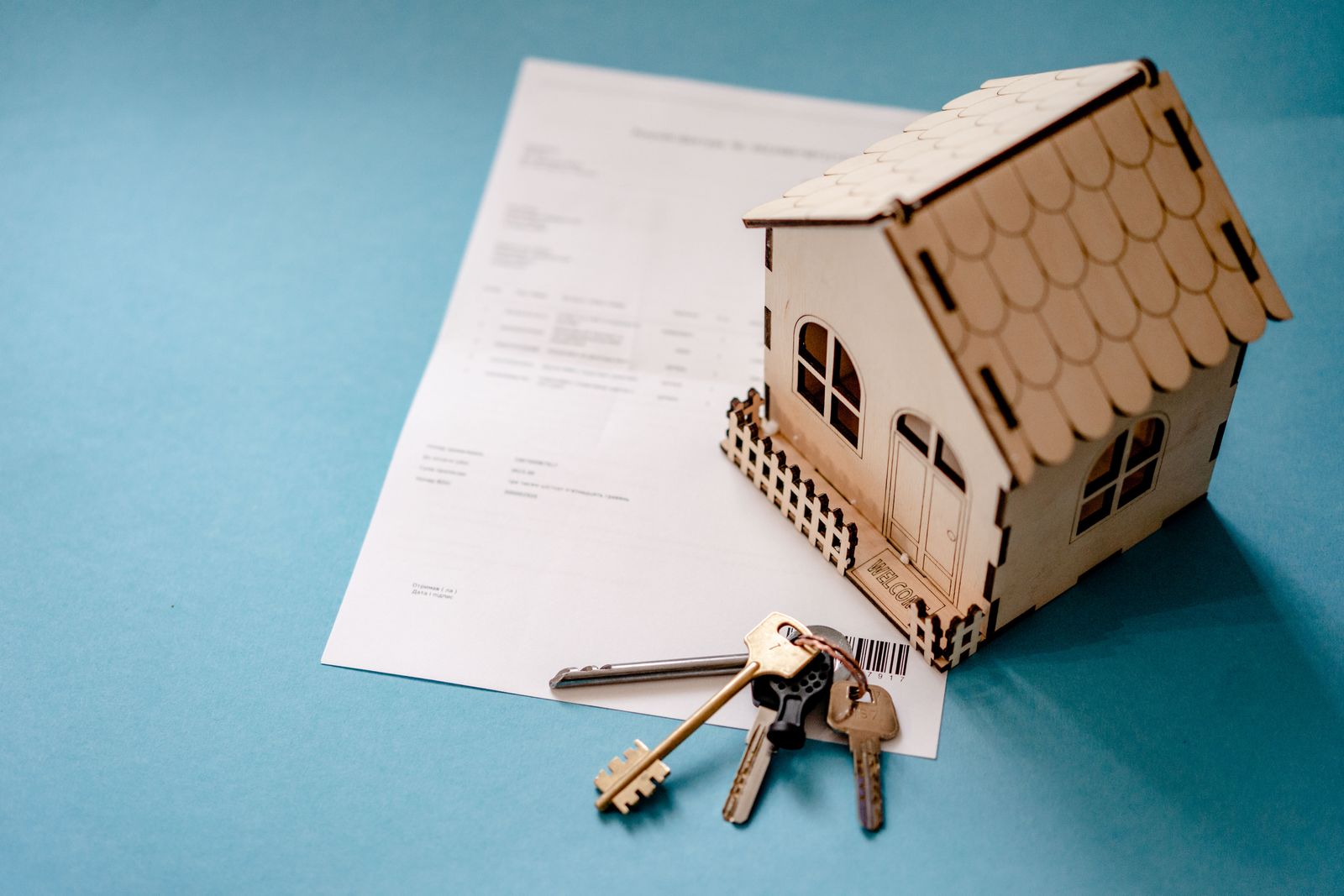 Landlord harassment in Alberta: house model, keys and a lease agreement